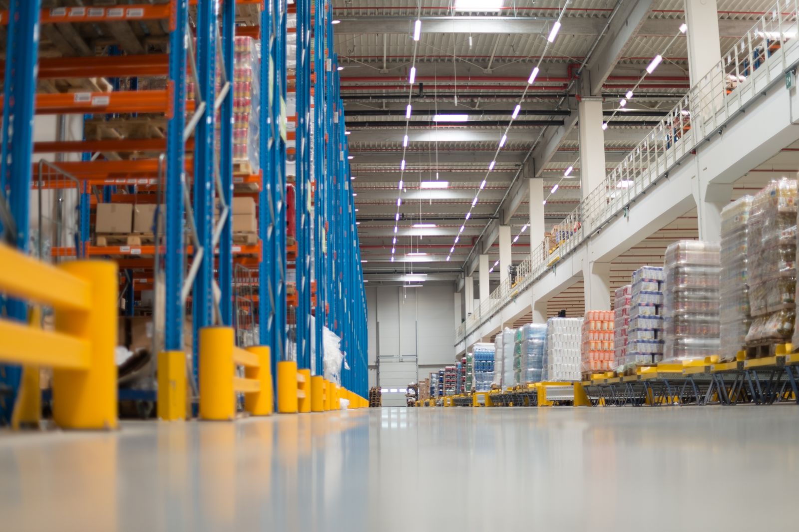 Warehouse aisle with a coated concrete floor between storage racks